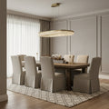 Elegant dining room features a wooden table, eight beige upholstered chairs, geometric rug, decorative centerpiece, large window with sheer white curtains, and the Morsale.com Bergamo Crystal Dining Chandelier for a modern touch.