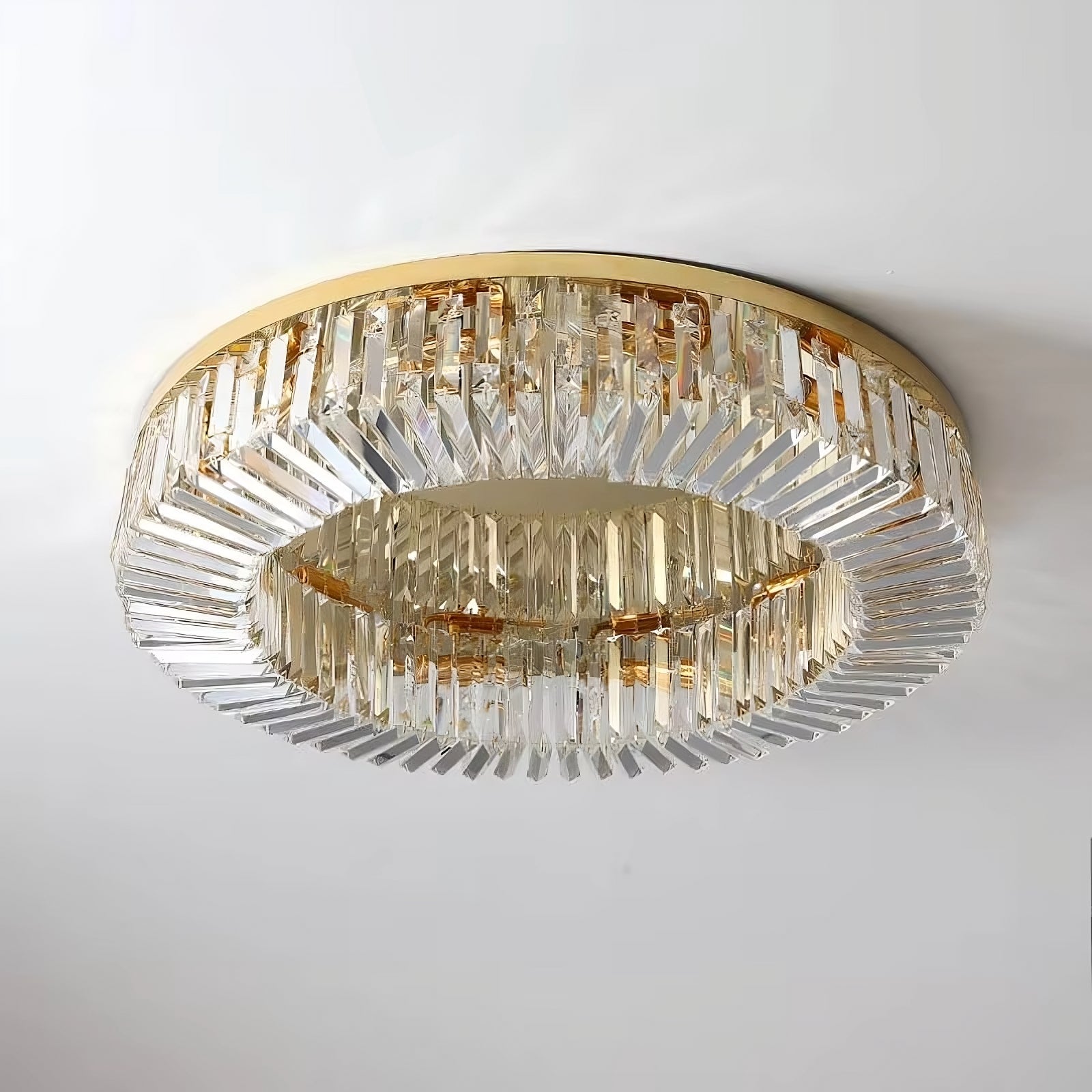 A close-up of the luxurious Specchio Crystal Ceiling Light Fixture by Morsale.com. This flush mount chandelier features a circular design with multiple layers of clear, rectangular crystal prisms set in a golden frame, creating an elegant addition to modern decor.