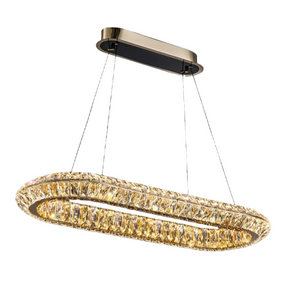 A modern, oval-shaped Bacci Crystal Kitchen Chandelier by Morsale.com is suspended from a rectangular black and gold mount by four slender wires. This elegant dining room lighting fixture is composed of numerous small crystals forming a loop that emits a warm, golden light.