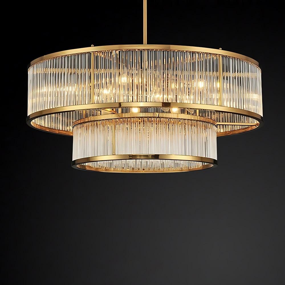 Introducing the Gerano Modern Chandelier by Bigman: a chic lighting fixture featuring a gold frame and vertical glass rods arranged in a sophisticated cylindrical pattern. This chandelier, equipped with LED bulbs, casts a warm and elegant glow that enhances its luxurious look against any dark backdrop.