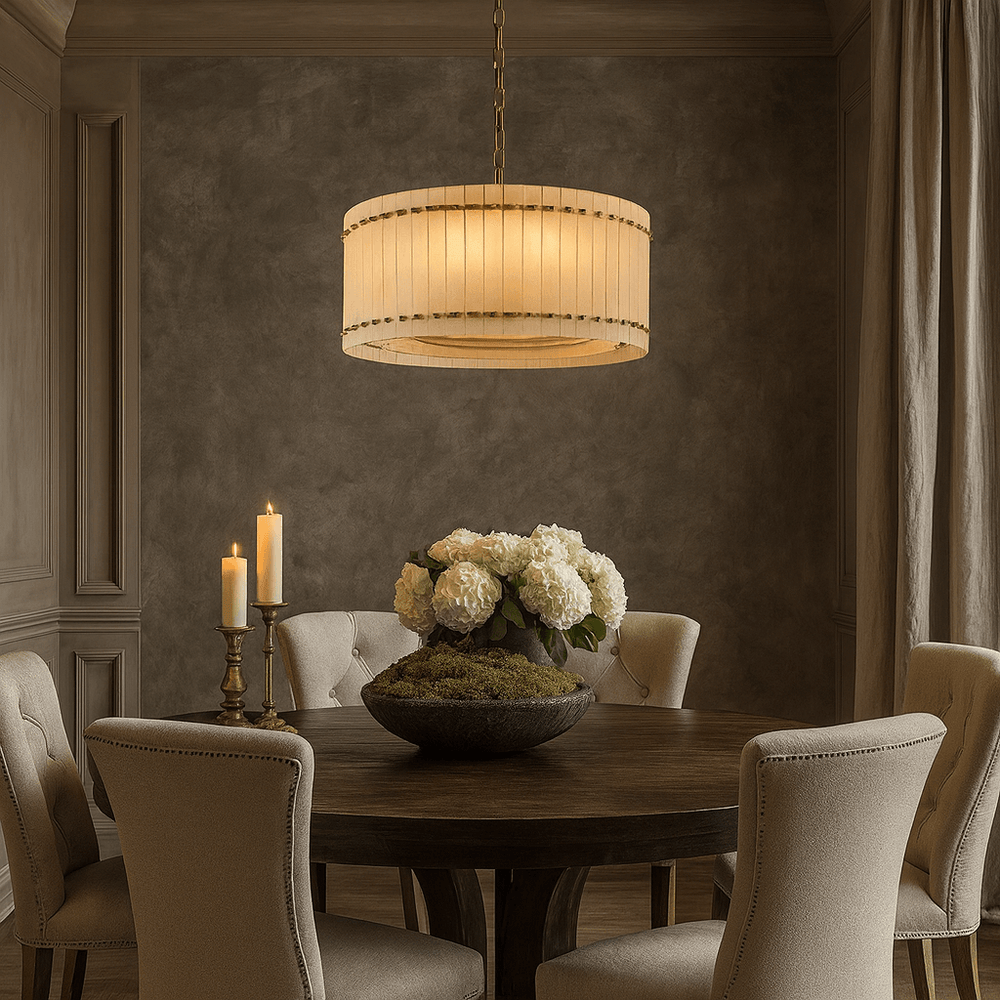 
                  
                    A round wooden dining table with beige upholstered chairs, white flower centerpiece, two brass candle holders, and the Morsale Valmont Marble Round Chandelier 24" illuminating the elegant, softly lit room.
                  
                