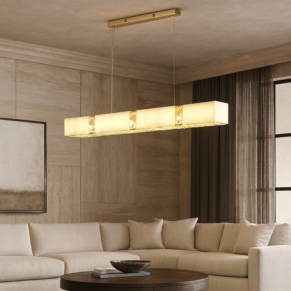 
                  
                    A modern living room with a beige sectional sofa, round wooden coffee table, and the Kolia Natural Marble & Crystal Ceiling Chandelier casting a warm glow. Neutral tones and a large window create an elegant, cozy atmosphere.
                  
                