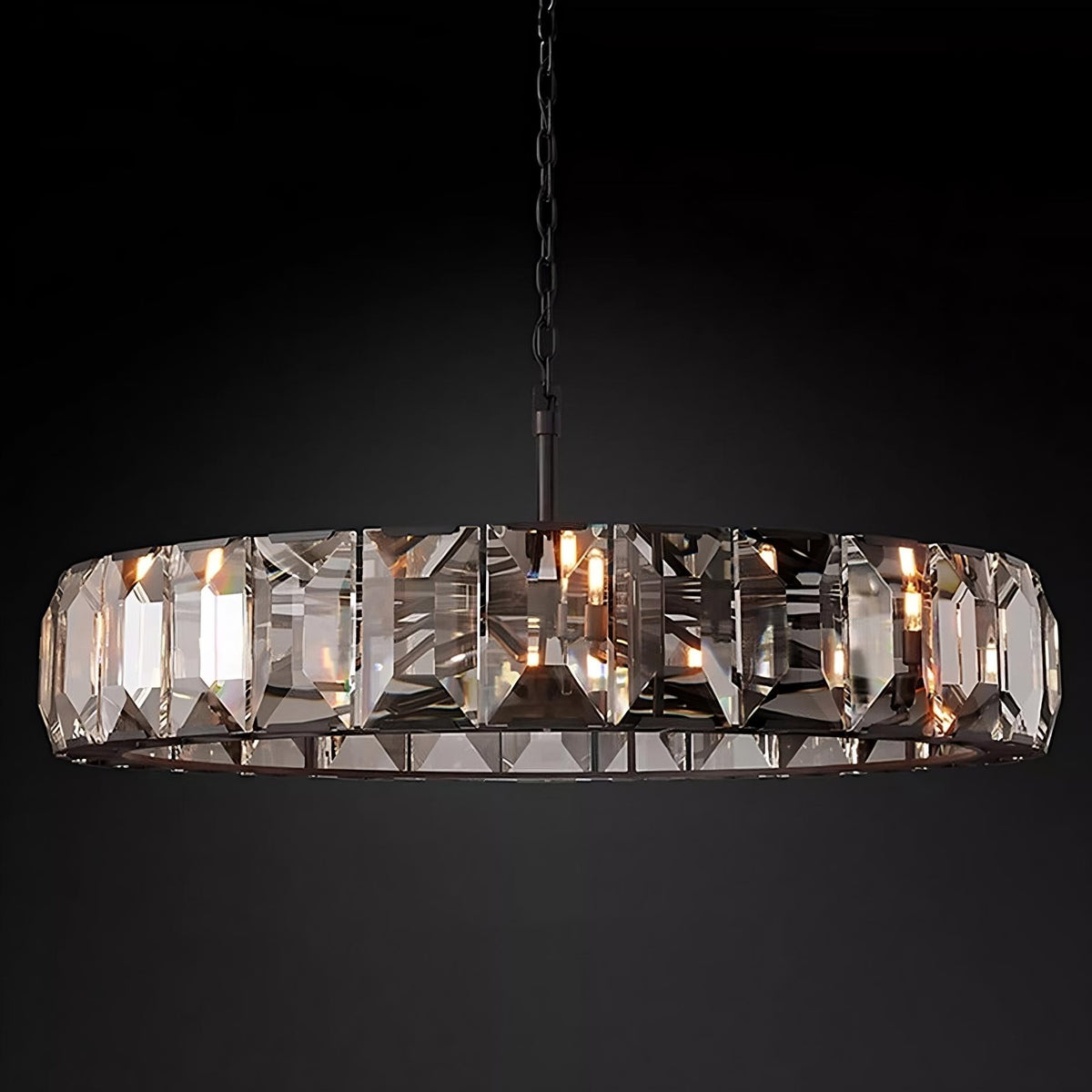 A Villano Crystal Chandelier from Morsale.com, featuring a sleek black chain and frame, hangs elegantly against a dark background. The chandelier showcases large, hand-crafted rectangular crystals that beautifully reflect light from small E14 LED bulbs, creating an elegant and sophisticated appearance.