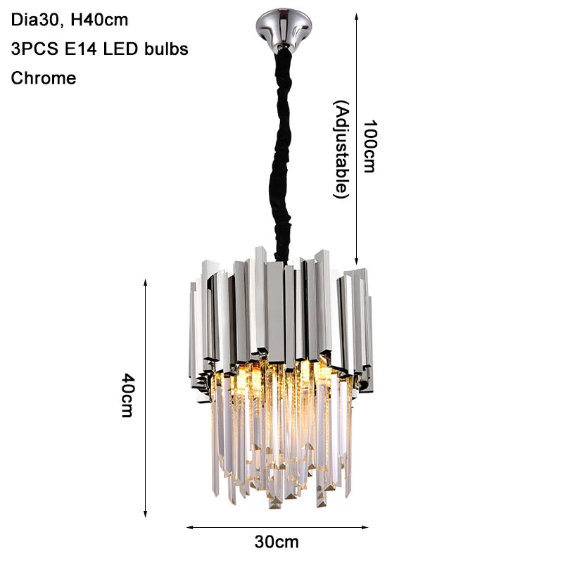 The Gio Crystal Kitchen Light Fixture by Morsale.com is a hanging chrome chandelier measuring 40cm in height and 30cm in diameter. Constructed with K9 crystal and stainless steel, it features overlapping metallic and glass prisms that encase three E14 LED bulbs, with an adjustable hanging length of up to 100cm.