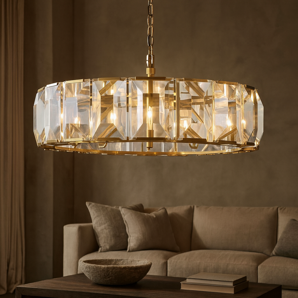 
                  
                    The Brookhill Crystal Chandelier by Morsale.com hangs above a beige sofa and coffee table, adding luxurious lighting to the warmly lit, minimalist living room.
                  
                