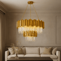 Gio 2-Tier Crystal Chandelier hanging in a stylish living room, featuring a gold finish and elegant crystal elements.