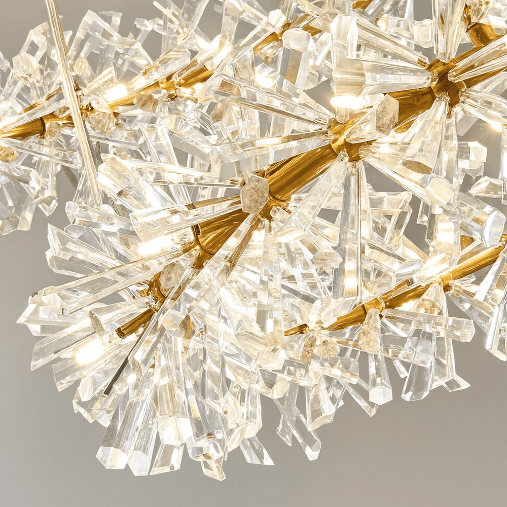 
                  
                    Close-up of the Exton Crystal Chandelier by Morsale.com, featuring clusters of clear prisms on gold stems, with warm light reflecting through the crystals against a neutral background.
                  
                