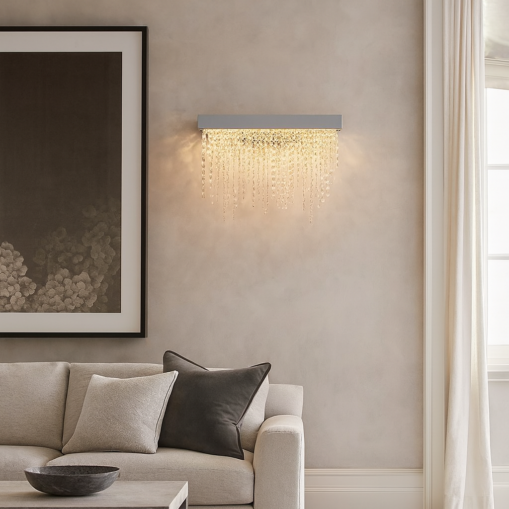 Modern living room with a beige sofa, wall art, and decorative light fixture.