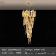 The Albero Crystal Foyer Chandelier by Morsale.com features an elegant, cascading design with multiple tiers of K9 crystals and a polished gold finish, warmly illuminated. The image details the size, voltage, light source, and materials: aluminum and crystal.