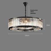 A **Gio Crystal Modern Chandelier** by **Morsale.com** with a handmade crystal design hangs from a black chain. The chandelier features a circular black frame with vertical handmade crystal panels and is 150 cm wide. The hanging chain is adjustable up to 100 cm, and the chandelier itself is 25 cm high.