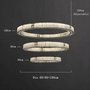 Marble & Crystal Modern Chandelier by Morsale.com with three concentric circular light fixtures of diameters 60 cm, 80 cm, and 100 cm. The light arrangement hangs from the ceiling with adjustable lengths up to 250 cm. The rings have a sleek, contemporary design and a metallic finish.