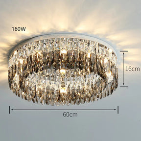 The Giano Crystal Ceiling Light from Morsale.com is a round handmade chandelier mounted on the ceiling. With a silver base and multiple rows of sparkling crystals, it measures 60 cm in diameter, 16 cm in height, and has a 160W light capacity, casting an elegant glow and adding classic luxury to any room.