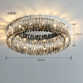 This image showcases the Giano Crystal Ceiling Light by Morsale.com with a luxurious circular design, emitting warm light. Measuring 80 cm in diameter and hanging 16 cm from the ceiling, this handmade chandelier has a power output of 240W. The multi-faceted crystals reflect light beautifully, epitomizing classic luxury.