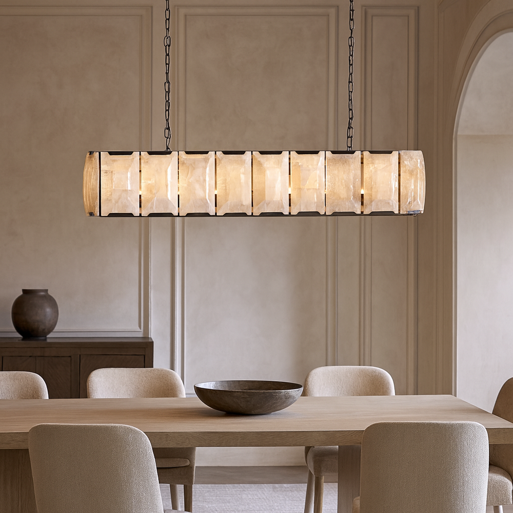 A modern dining room features a rectangular wooden table, six beige chairs, a round bowl centerpiece, a sideboard with a vase, and the Brookhill Calcite Dining Chandelier by Morsale.com as the perfect modern lighting above the table.