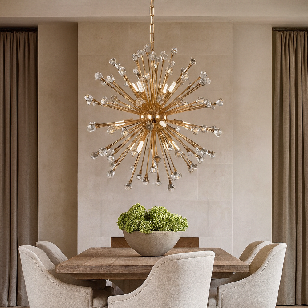 A modern dining room features a wooden table, four upholstered chairs, a bowl of green hydrangeas, and the Weston Sputnik Chandelier by Morsale.com with crystal accents overhead. Beige curtains frame the neutral-toned walls.
