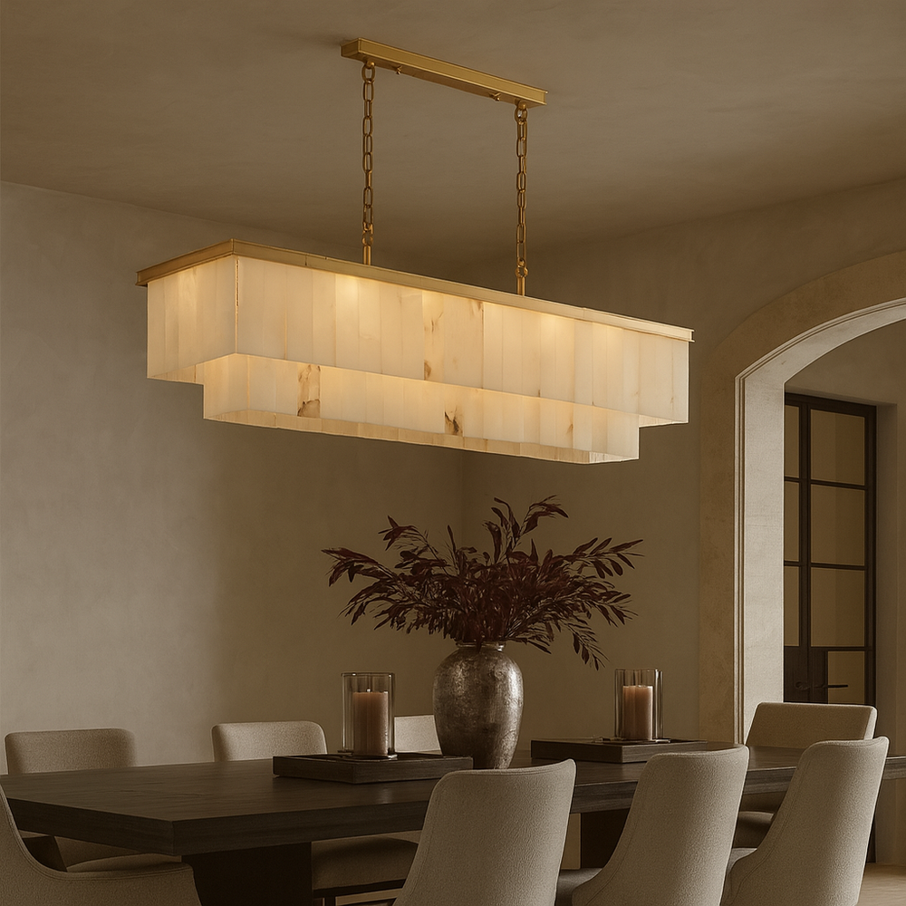 A modern dining room showcases the Shopp578 Beano Marble Dining Chandelier above a dark wood table adorned with candles and a large foliage vase. Upholstered chairs and neutral walls complete this elegant, layered setting.