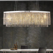 Elegant Alleri Crystal Dining Room Chandelier with handmade crystals and chrome finish, illuminating a modern dining space.