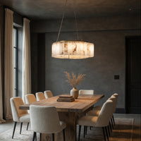 Dining room with wooden table and chairs under a pendant light.