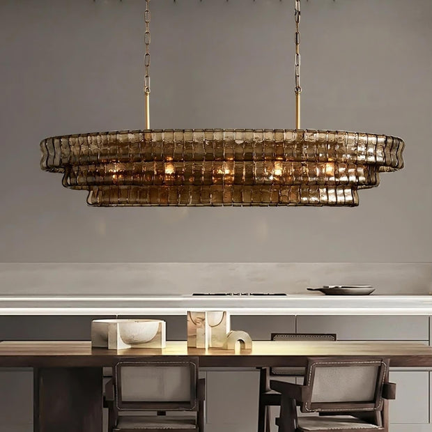 Riviera oval smoke glass chandelier over a dining table