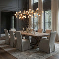 Albero Brass Branch Chandelier illuminating a dining table in a stylish interior with soft curtains and elegant decor.