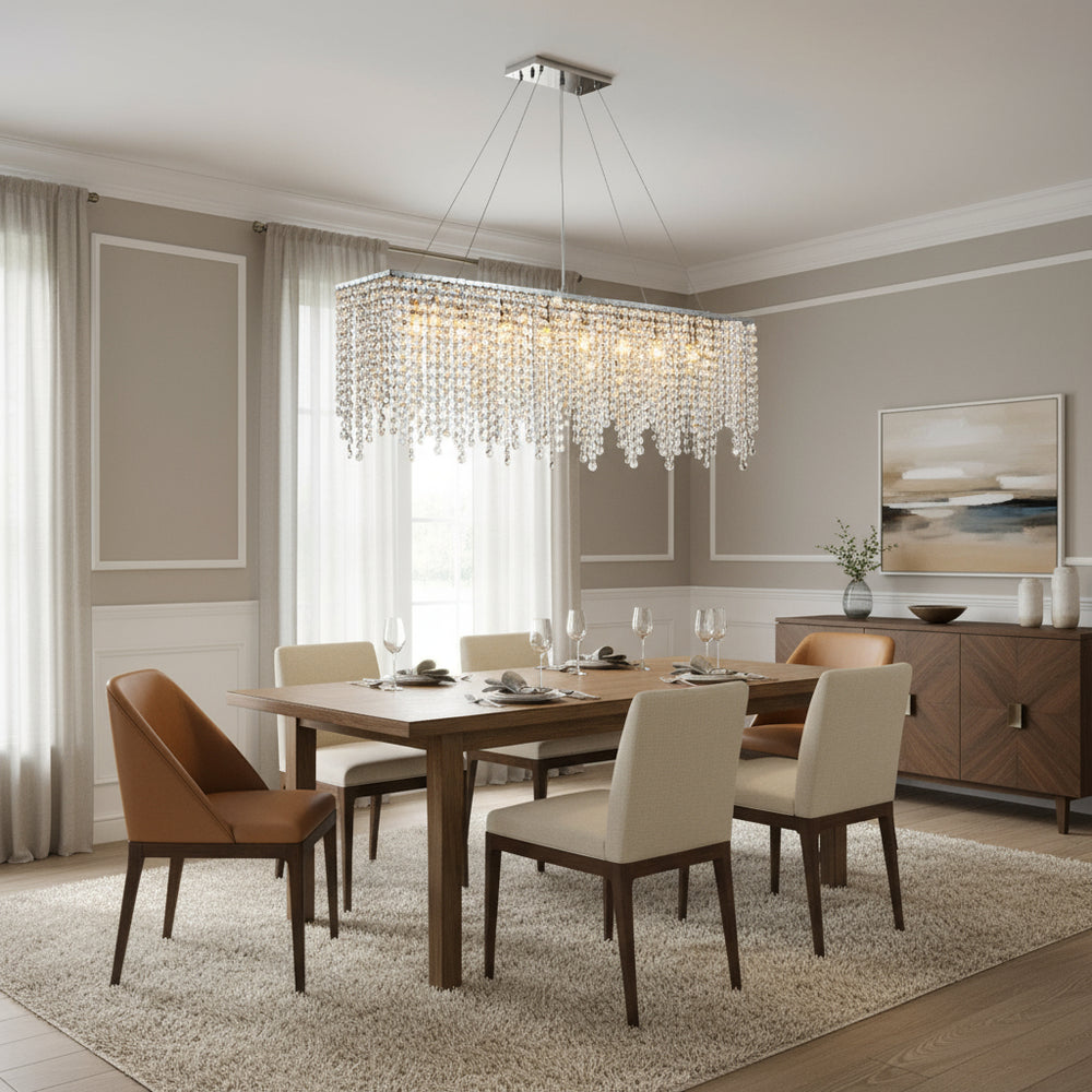 A modern dining room with a wooden table, six upholstered chairs, the Alleri Crystal Dining Chandelier by Morsale.com above, neutral walls, large windows with sheer curtains, a sideboard, and a contemporary landscape painting.