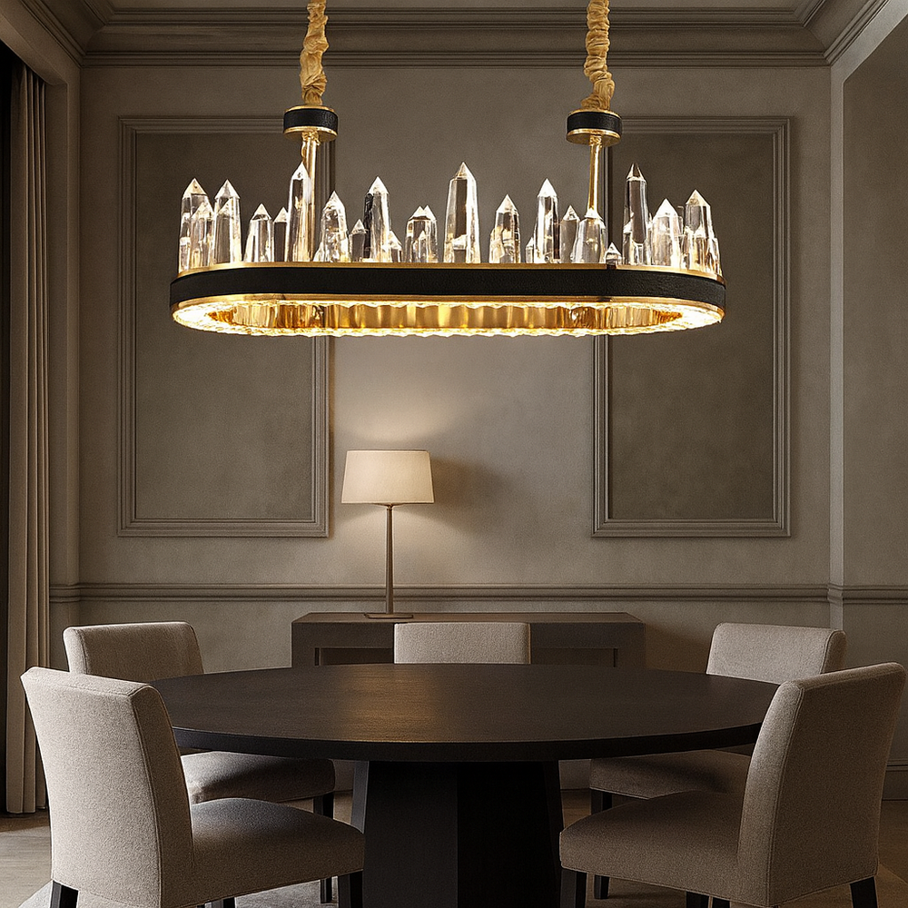 A modern dining room features a round dark table, four upholstered chairs, a floor lamp, and the Gainford Dining Chandelier by Morsale.com with crystal-like spikes. Elegant molding adds detail to the walls.