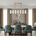 Lunara linear marble chandelier over a dining table