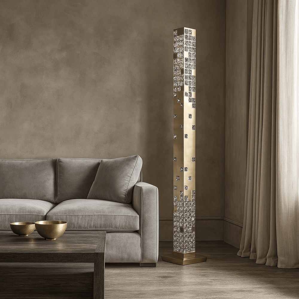 
                  
                    A modern living room with a beige sofa, wooden coffee table holding two gold bowls, and the Morsale Aurelia Crystal Tower Floor Lamp—an elegant geometric crystal design—illuminating the space beside soft beige curtains.
                  
                