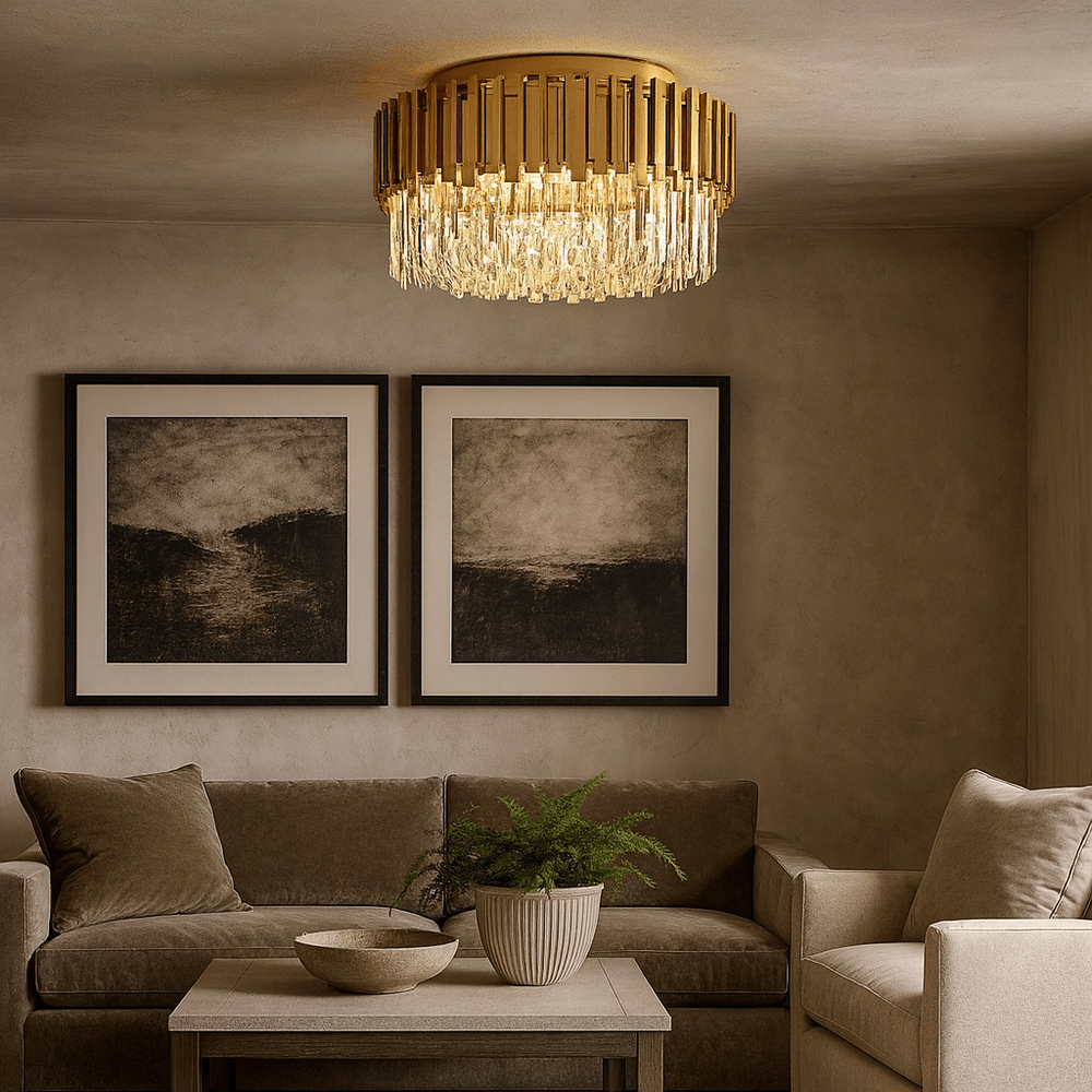 A modern living room with beige walls, a tan sectional sofa, two abstract black-and-white artworks, a coffee table with a plant, and the Gio Flush Mount Chandelier by Morsale.com adding elegance from the ceiling.