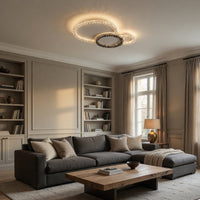 Modern living room with a gray sofa, wooden coffee table, and bookshelves.