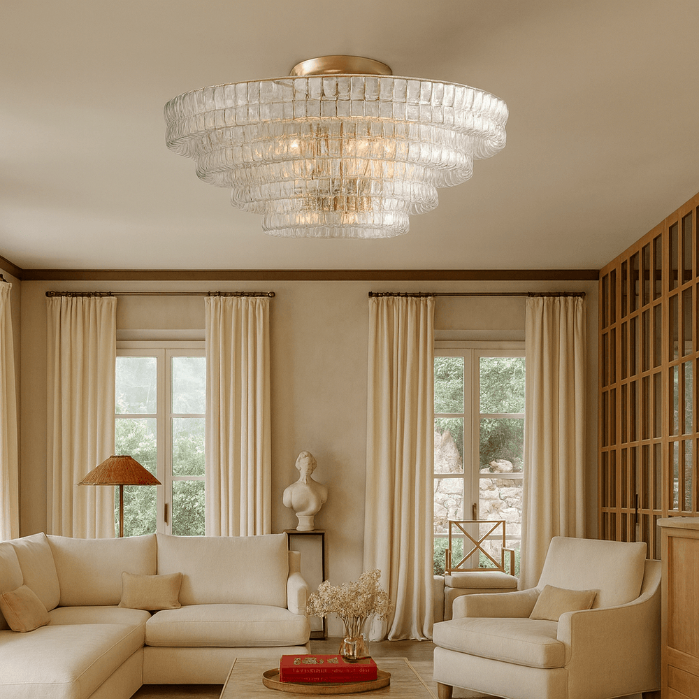 Elegant living room with cream sofas, sheer curtains, and wood accents. The Morsale Riviera 35" Flush Mount adds a contemporary touch overhead as natural light pours in. A sculpted bust sits on a corner table.