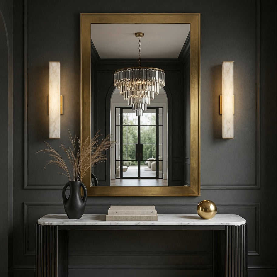 Elegant interior design with a large mirror, chandelier reflection, and decorative items on a console table.