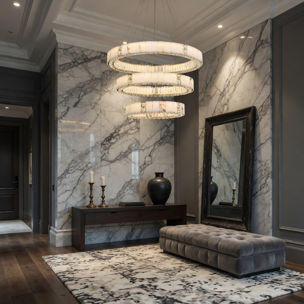 Luxurious interior with marble walls, a chandelier, and decorative items.