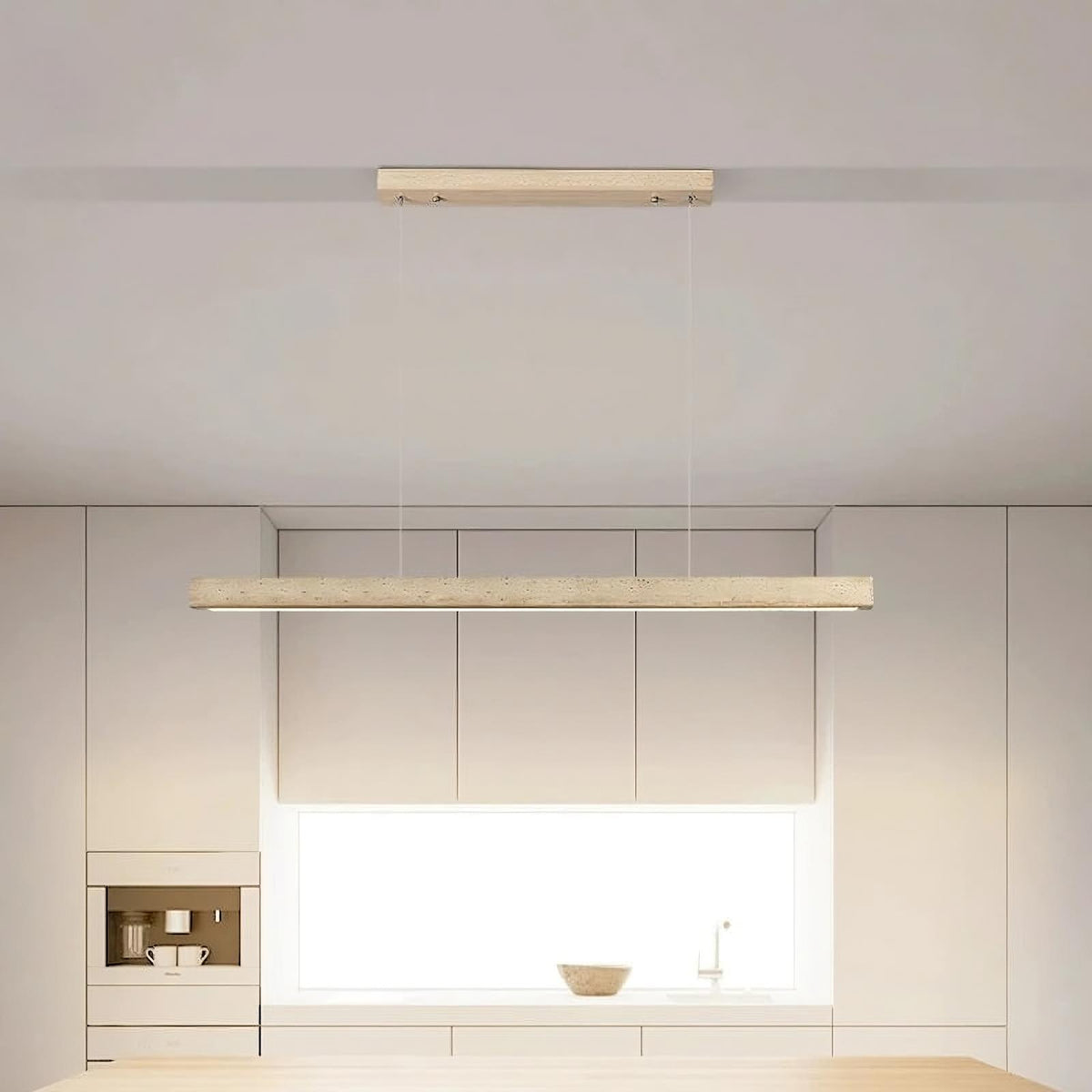 A minimalist, modern cord pendant light fixture from Morsale.com hangs from a high ceiling in a stylish, contemporary room. The Natural Travertine LED Kitchen Light Fixture features a long, rectangular wooden beam with LED bulbs suspended by two thin, nearly invisible cables. The room has clean lines and subtle beige tones.