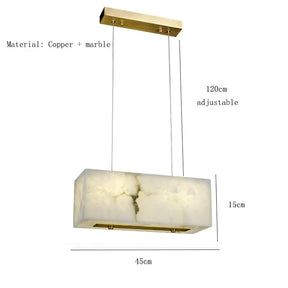 The Natural Marble Dining Room Chandelier by Shopp578 boasts a modern minimalistic design, featuring a translucent alabaster shade. This rectangular pendant light fixture is suspended from a rectangular gold metal plate by two thin wires, offering warm ambient lighting against a plain gray background.