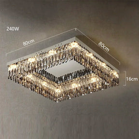 A square Giano Crystal Ceiling Light by Morsale.com with dimensions 80cm by 80cm and a height of 16cm. This luxury chandelier features multiple rows of dangling crystals and emits a warm light, marked with 240W indicating its power consumption. The background is a plain wall.