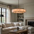 Brookhill Modern Calcite Chandelier with iron frame and natural stone prisms glowing in a living room.