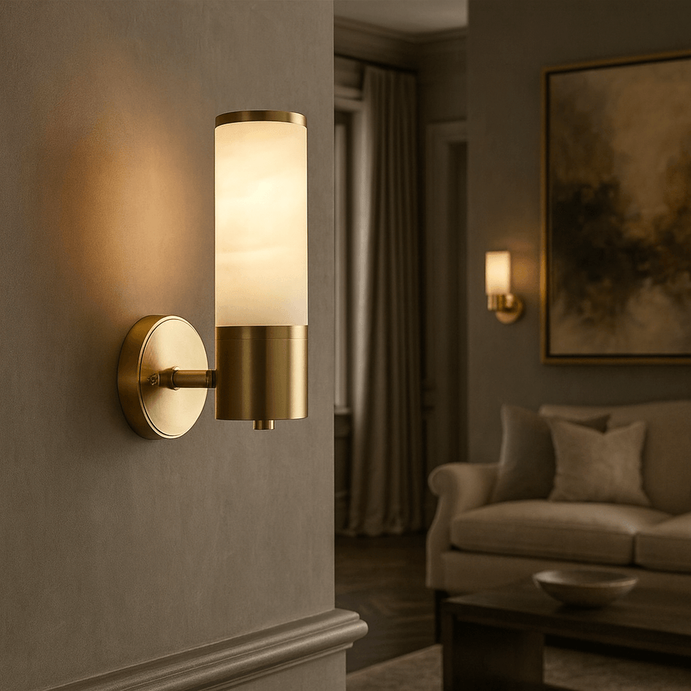 The Sierra Marble Wall Sconce from Morsale.com, featuring brass and frosted glass, adds a refined touch to taupe living room walls with sofas, cushions, a large painting, and a matching sconce for sophisticated modern style.