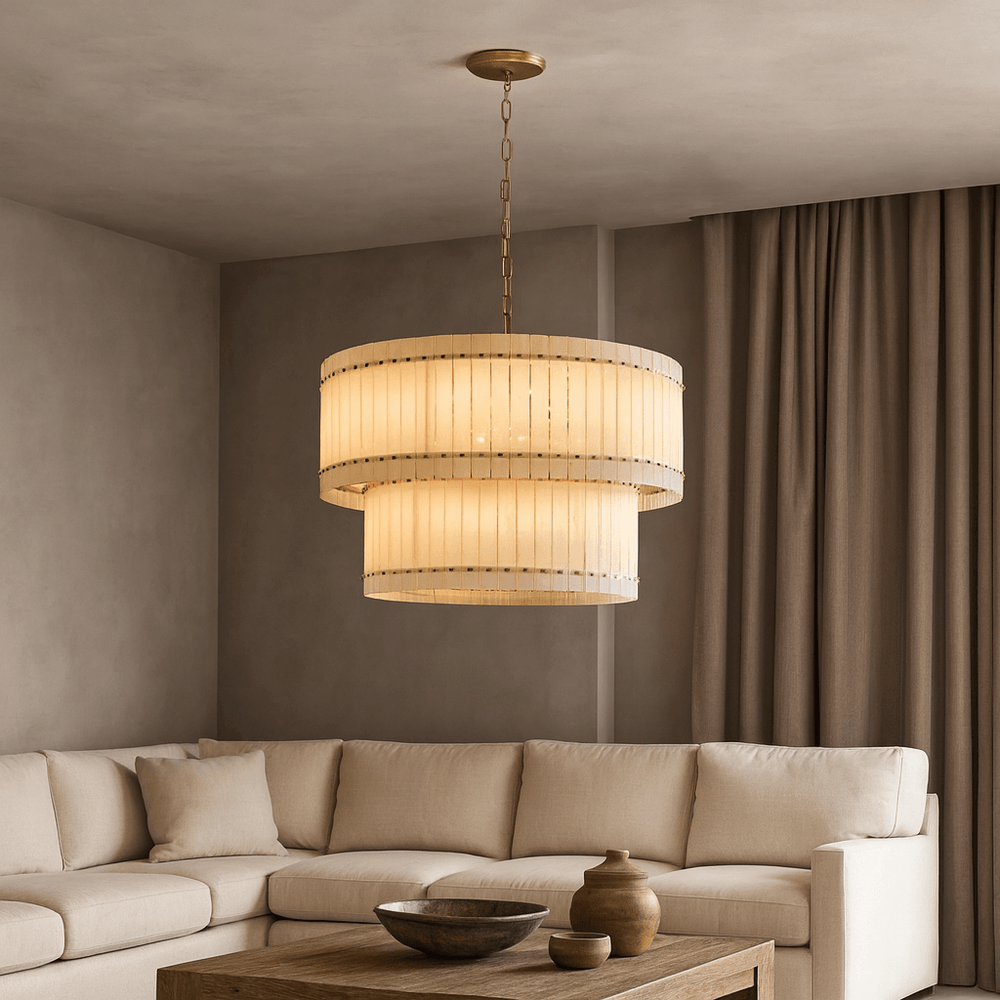 
                  
                    A modern living room featuring a large beige sectional, wooden coffee table with ceramic decor, and sculptural lighting from the Morsale Valmont 2-Tier Marble Chandelier 39". Neutral tones and floor-length curtains complete the look.
                  
                