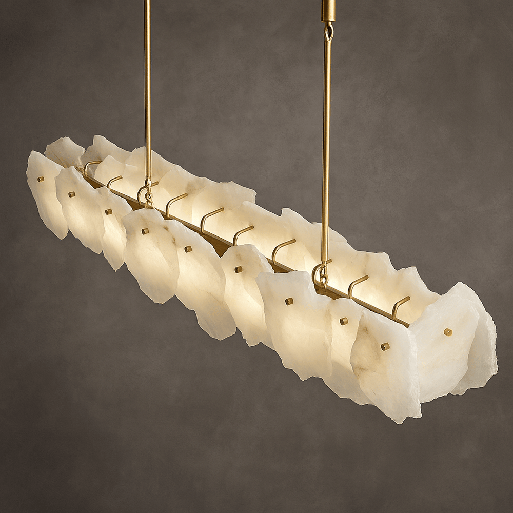 
                  
                    The Norham Marble Linear Chandelier by Morsale features gold rods and multiple translucent, irregular white panels, making it ideal luxury lighting for dining rooms, especially when set against a gray backdrop.
                  
                