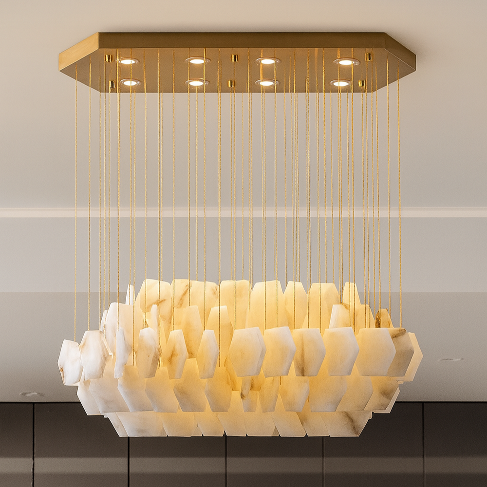 The Arden Marble Chandelier by Shopp578 features hexagonal marble-like pieces suspended by thin gold cords from a rectangular gold plate, offering a modern G9 LED design with a warm, elegant glow.