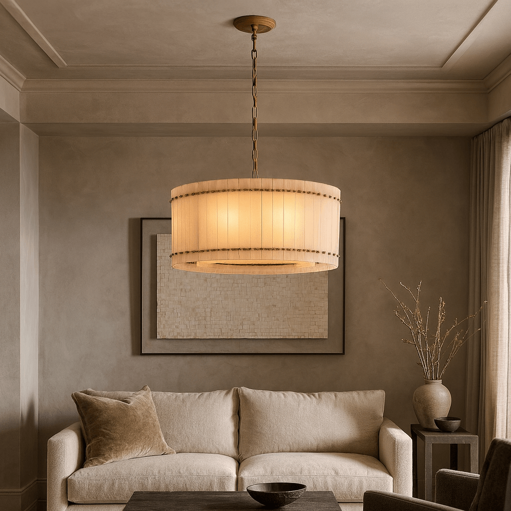 A beige living room features a plush cream sofa, round wooden coffee table, tall vase with twigs, and the Morsale Valmont Marble Round Chandelier 24" hanging above. Neutral wall art adds to the serene atmosphere.
