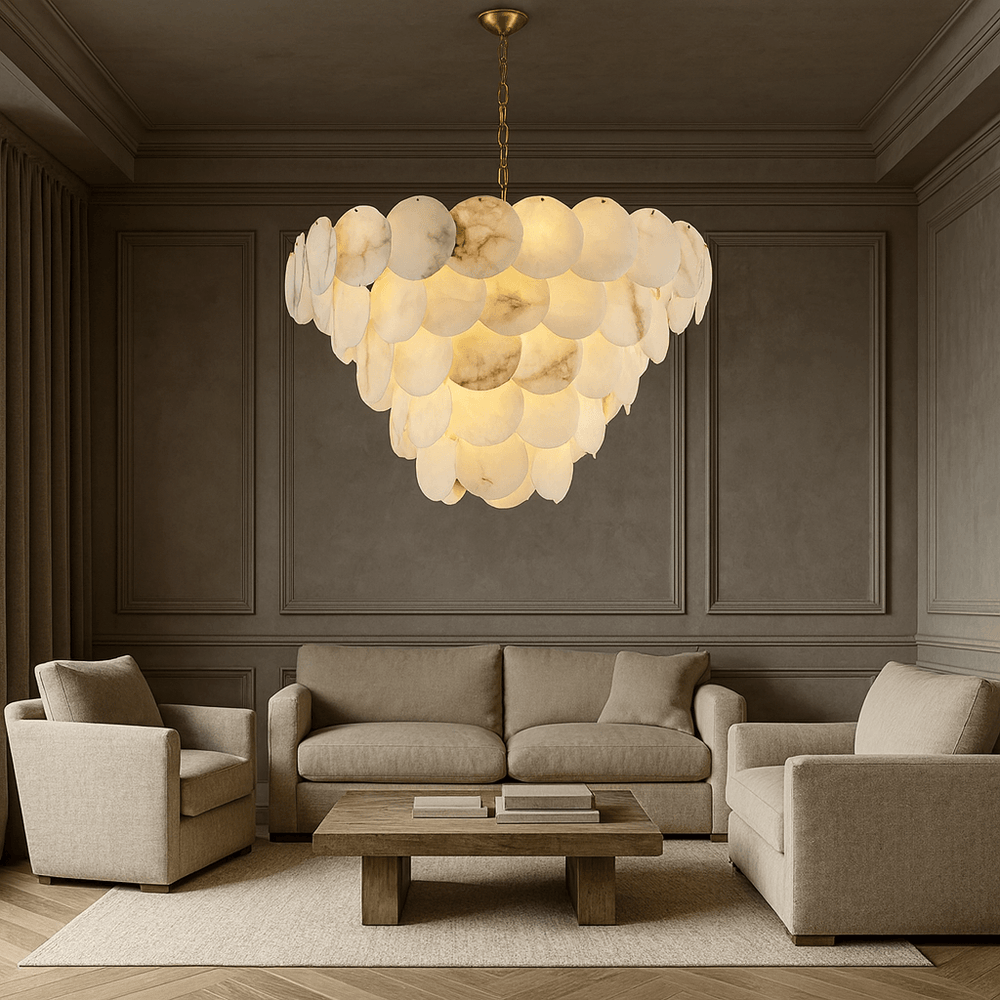 A sophisticated living room with neutral-toned walls, a beige sofa set, a wooden coffee table, and the elegant Bordwell Marble Chandelier 35" by Morsale.com featuring layered, glowing disc-shaped elements hanging from the ceiling.