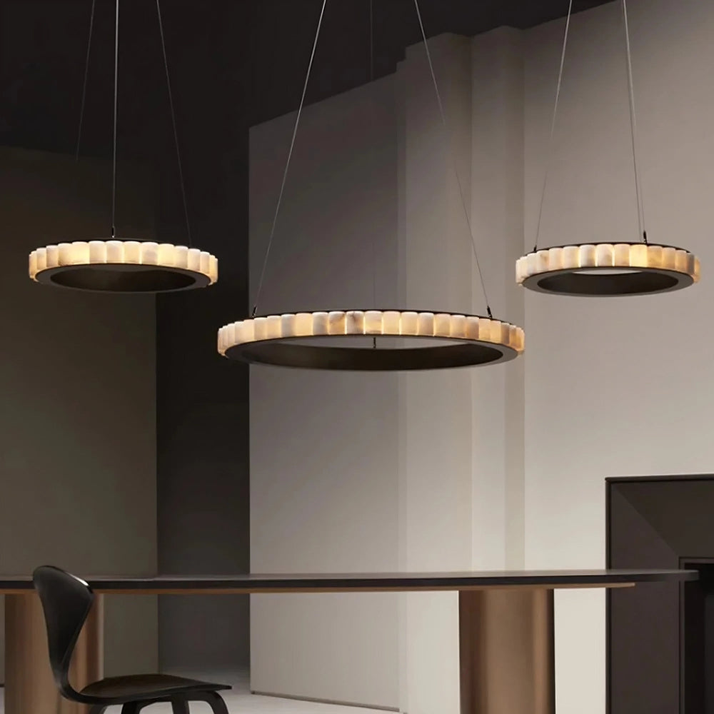 
                  
                    Modern dining room with a table and chairs under pendant lights.
                  
                