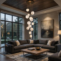 Modern living room with a sectional sofa, wooden coffee table, and hanging light fixture.