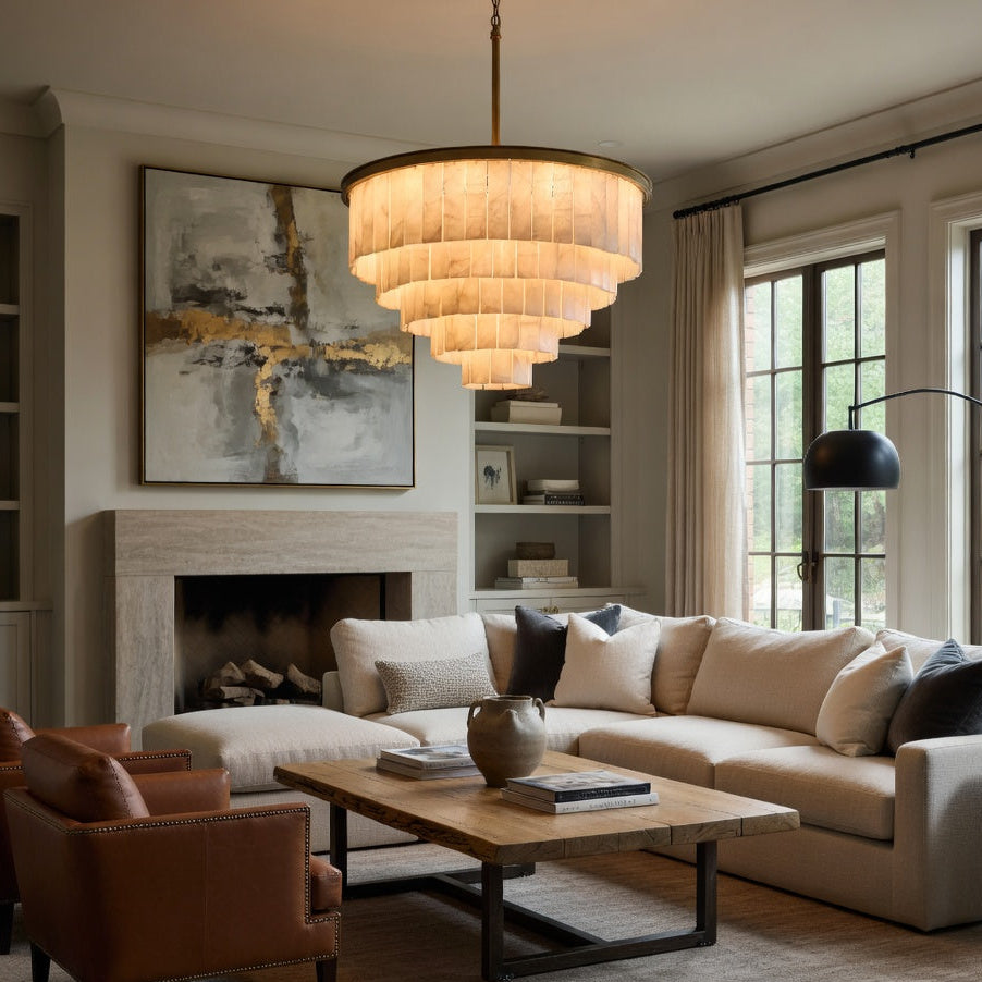 Modern living room with beige sectional sofa, brown armchairs, and a chandelier.