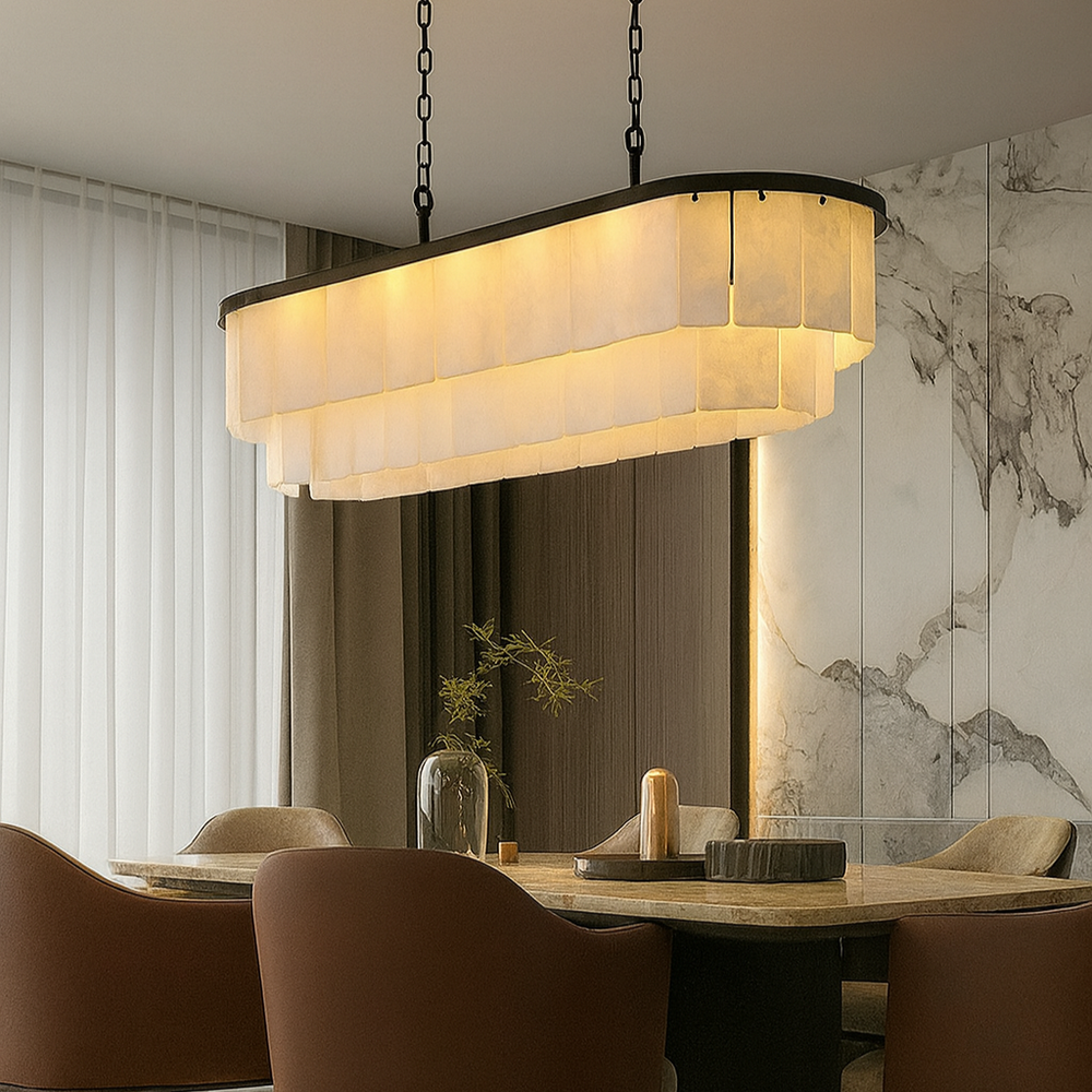 Modern chandelier hanging above a dining table with chairs in a stylish room.