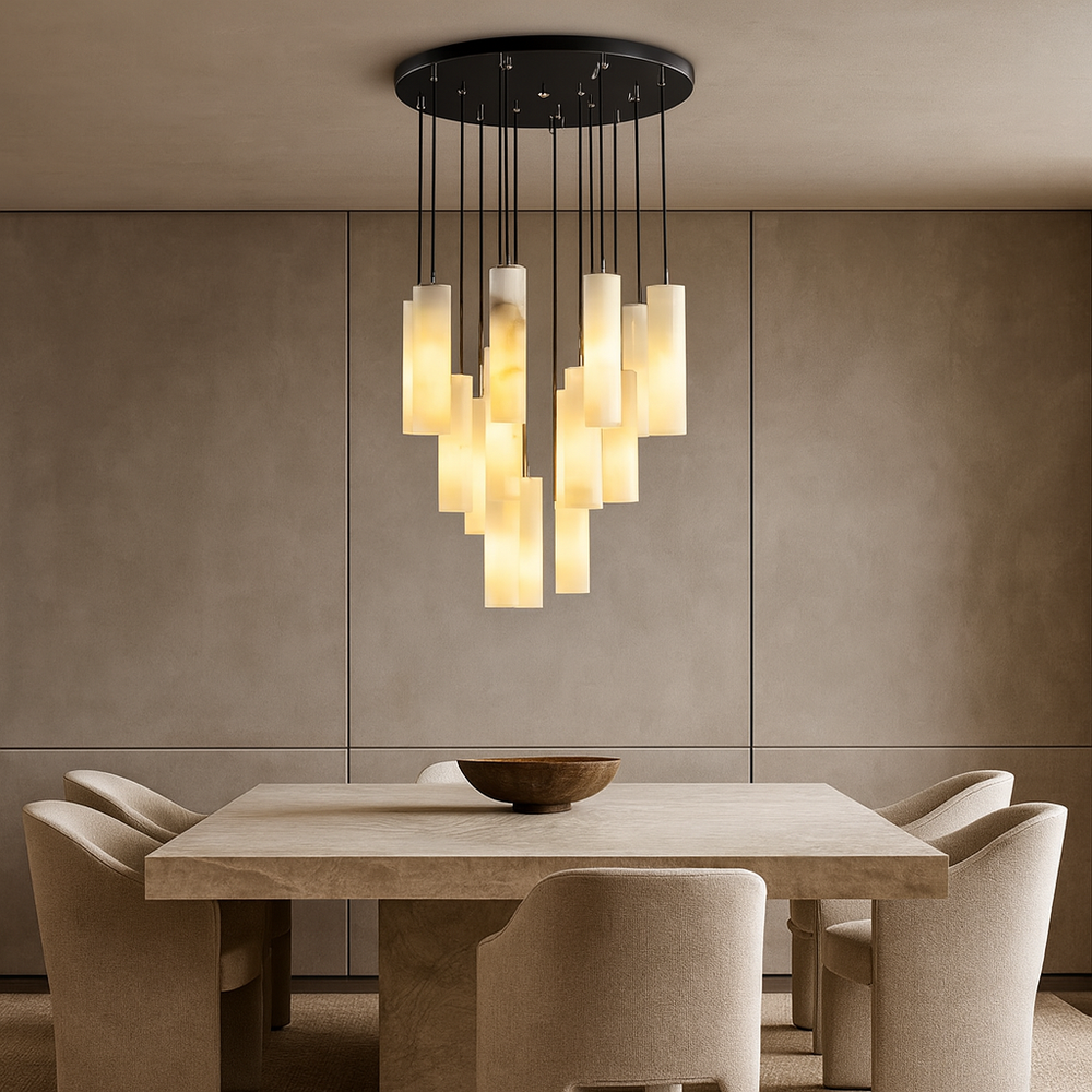A modern dining room features a rectangular stone table, four upholstered chairs, and the Moonshade Marble Pendant Light Fixture by Morsale.com overhead, casting a warm glow. A wooden bowl is placed at the center of the table.