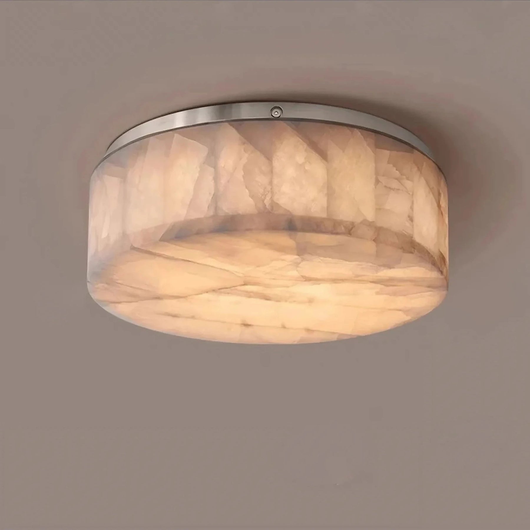 Introducing the Moonshade Natural Marble Ceiling Light Fixture from Morsale.com: a round, flush-mount ceiling light featuring a brushed nickel frame and a frosted, marble-patterned glass shade. The energy-efficient LED lights emit a warm glow, perfect for enhancing the modern minimalist look on any plain, beige ceiling.