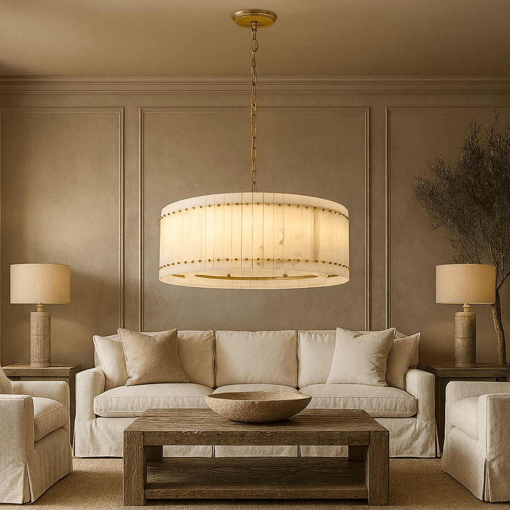 Neutral living room with a beige sofa, matching armchairs, two table lamps, a wooden coffee table, large decorative bowl, and the Morsale Valmont Marble Round Chandelier 31" elegantly suspended from the ceiling.